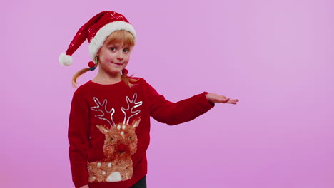 Girl-in-red-New-Year-sweater-deer-showing-thumbs-up-and-pointing-at-on-blank-advertisement-space