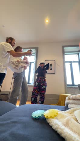 family interacting with vr headset and baby