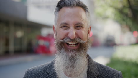 portrait-of-confident-businessman-with-beard-laughing-cheerful-enjoying-successful-urban-lifestyle-mature-male-entrepreneur-wearing-stylish-fashion-in-city-street-background-slow-motion