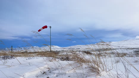 windsock blowing in the arctic winter wind at blönduos airfield in northern icelandic landscape