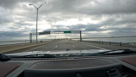 POV---Driving-on-the-Memorial-Causeway-over-Oso-Bay-in-Corpus-Christi,-Texas-on-a-cloudy-day