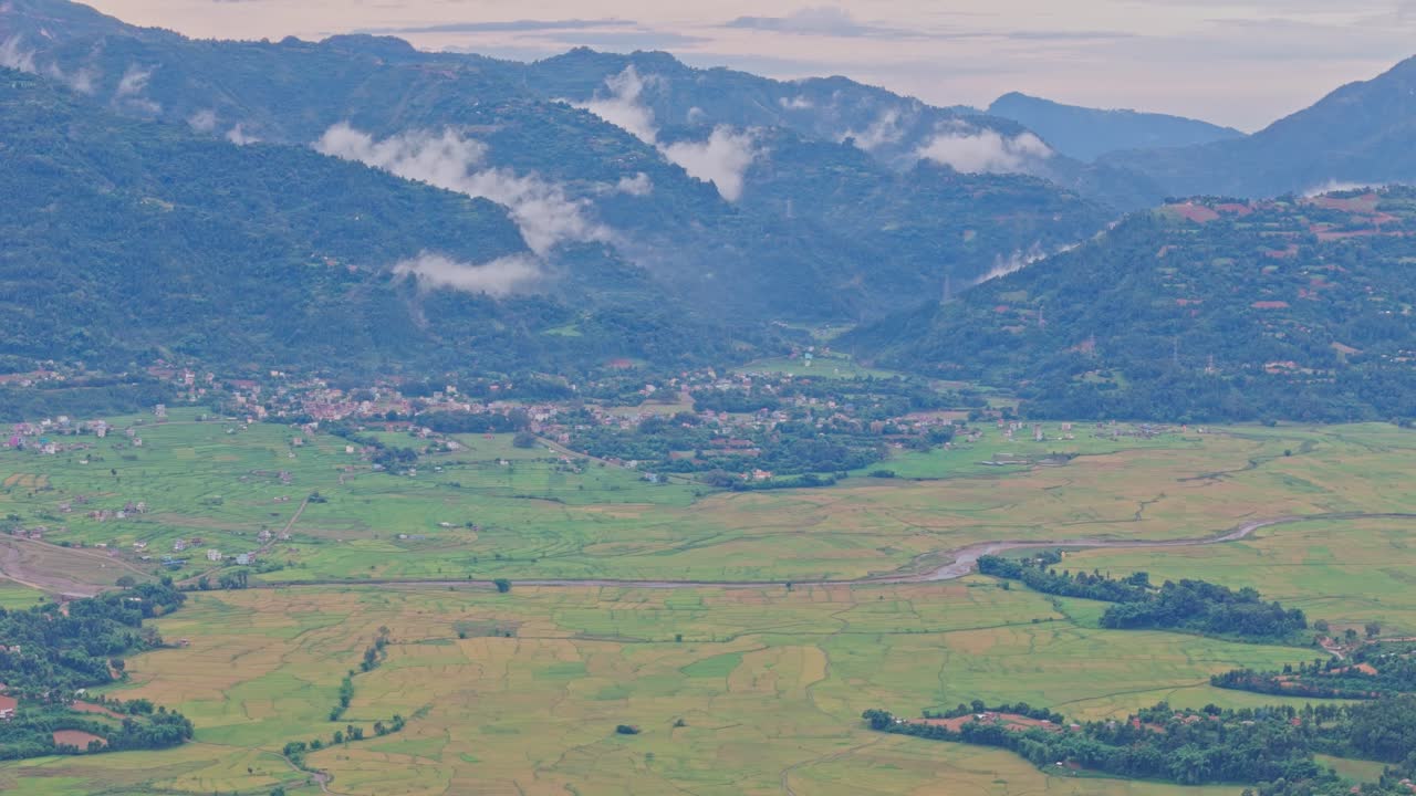 Aerial view of lush green paddy fields in Tansen Palpa, Nepal, surrounded by beautiful mountains and rural landscapes, showcasing the region’s rich agriculture and natural beauty