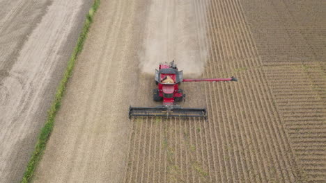 aerial, combine harvester collection grain crop from farm field