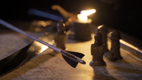 Arrow-and-sword-on-candlelit-war-map.