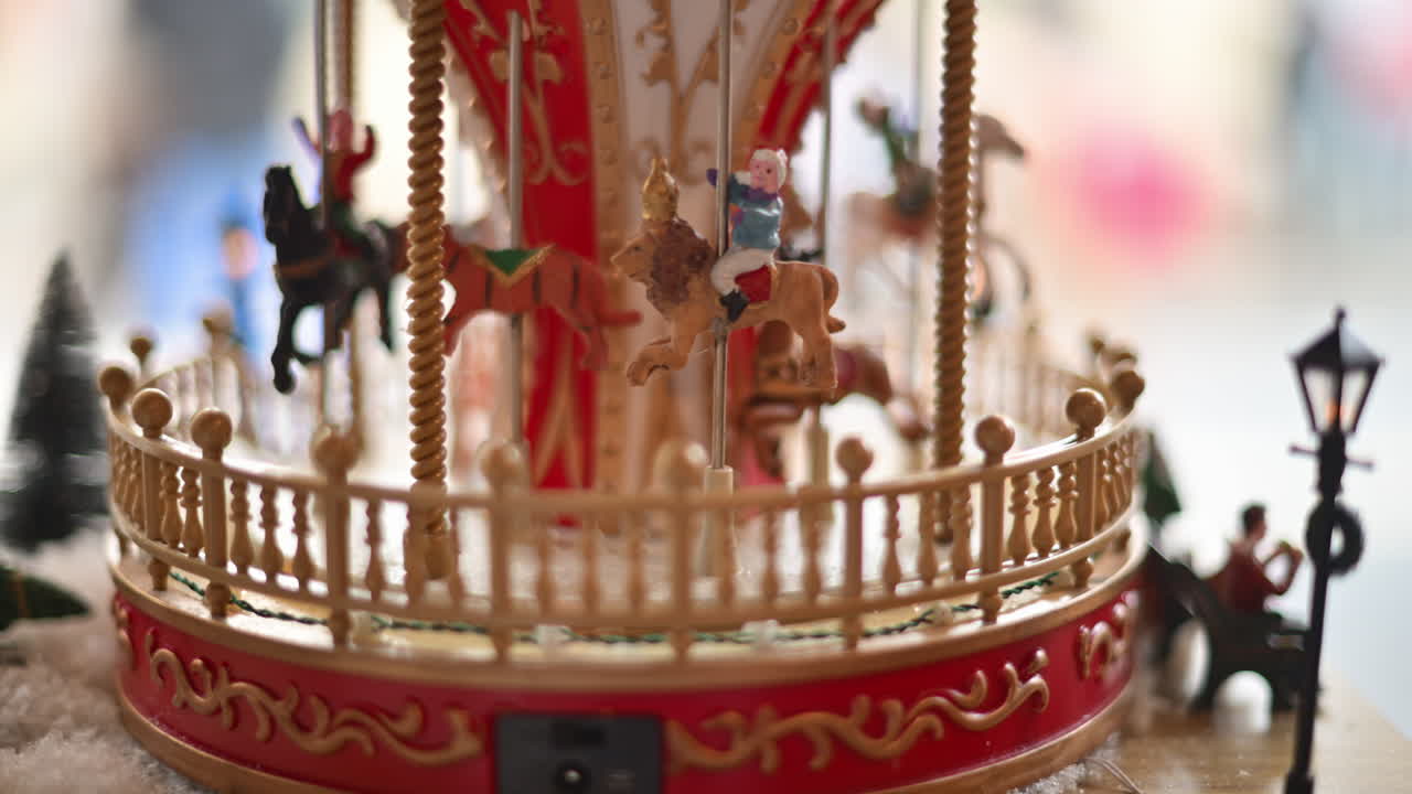 Close up of a miniature vintage carousel with decorative horses and ornate details