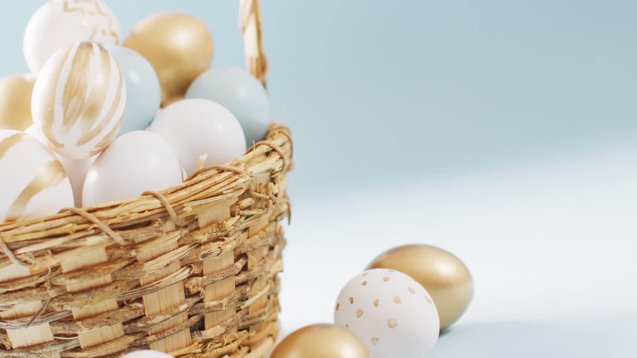 Basket with colorful easter eggs on blue background with copy space