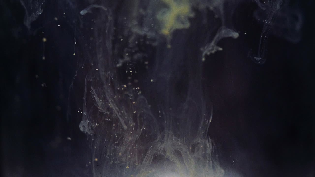 Colored paint floating in darkish water tank. Stable shot with the Sony a7iii