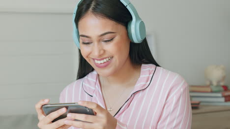 Headphones,-smartphone-and-woman-on-video-call