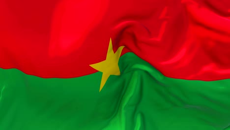 burkina faso flag waving in wind slow motion animation . 4k realistic fabric texture flag smooth blowing on a windy day continuous seamless loop background.