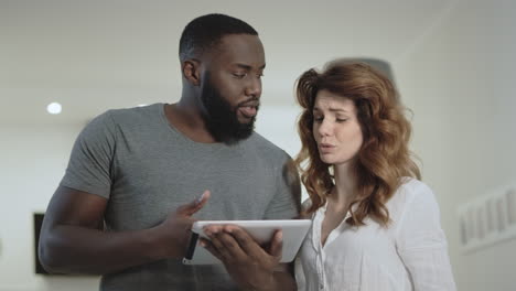 Young-couple-discussing-at-home