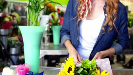 Female-florist-preparing-flower-bouquet