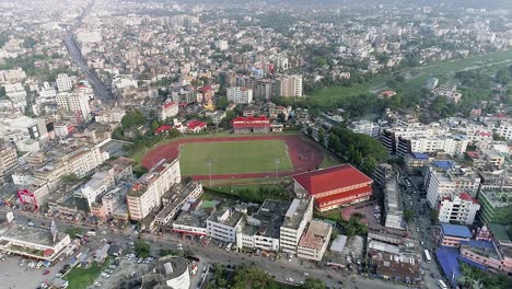 aerial view of football pitch close to railway and city park surrounded by residential buildings