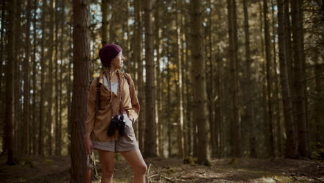 female explorer looking around in forest