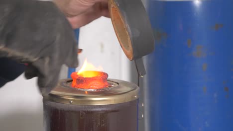 jeweler melting silver in a pot