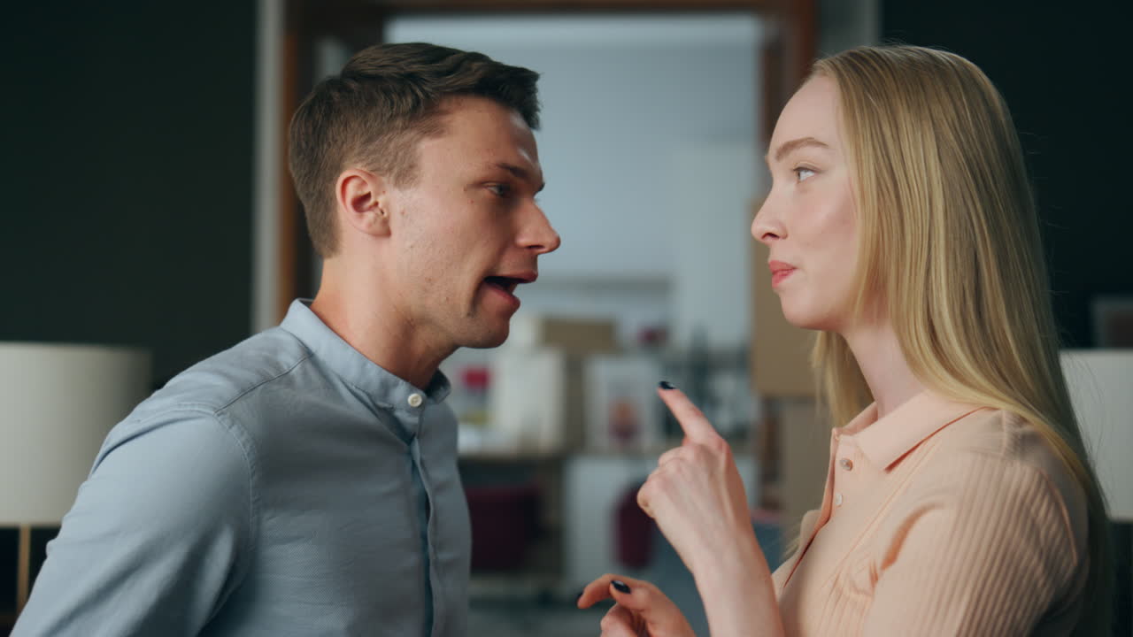 Married couple yelling home close up. Nervous man shouting with angry woman.