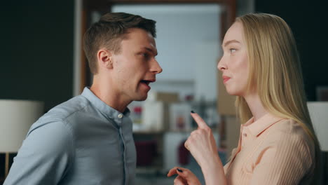 married couple yelling home close up. nervous man shouting with angry woman.