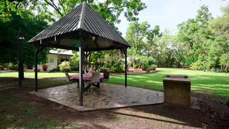 zona rural tropical de gran pérgola y jardín con césped cubierto de hierba y superficie dura de roca de hormigón