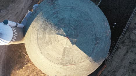 aerial view of a round barn and silo on a farm