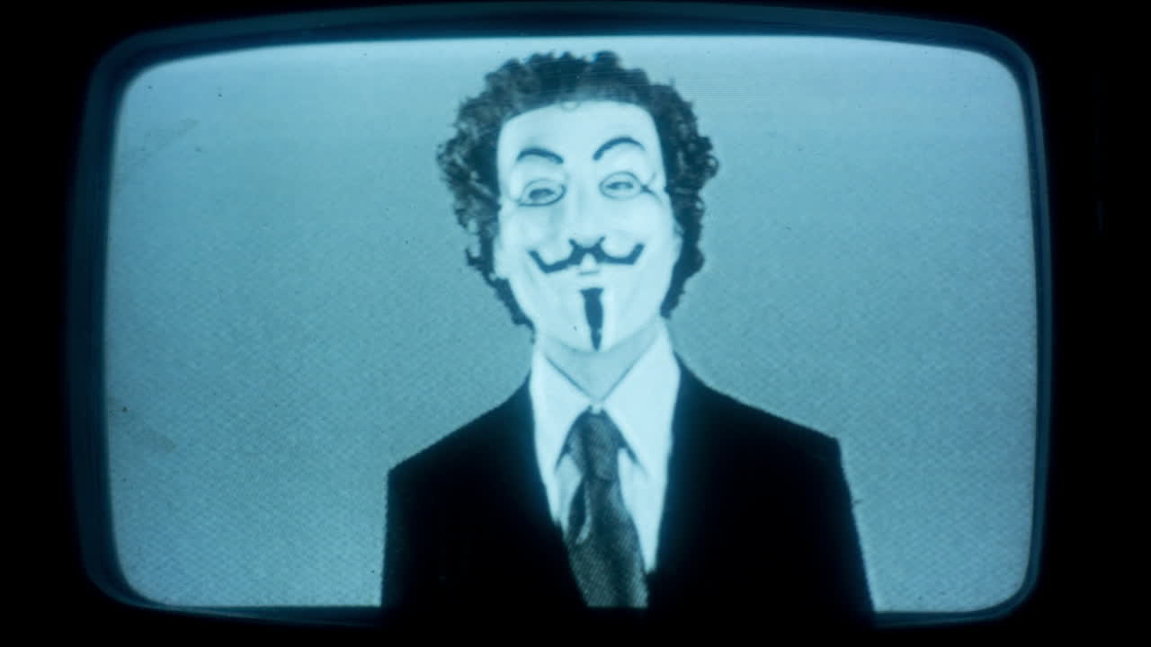 anon maksed man on burry screen 18