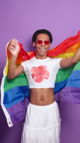 images of a person holding a rainbow flag