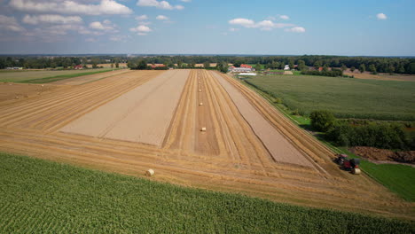 Golden-farm-field.-Agriculture-Tractor-Collecting-Hay