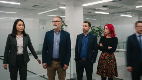 a diverse group of professionals engaged in serious discussion within a modern office environment, highlighting collaboration and team dynamics