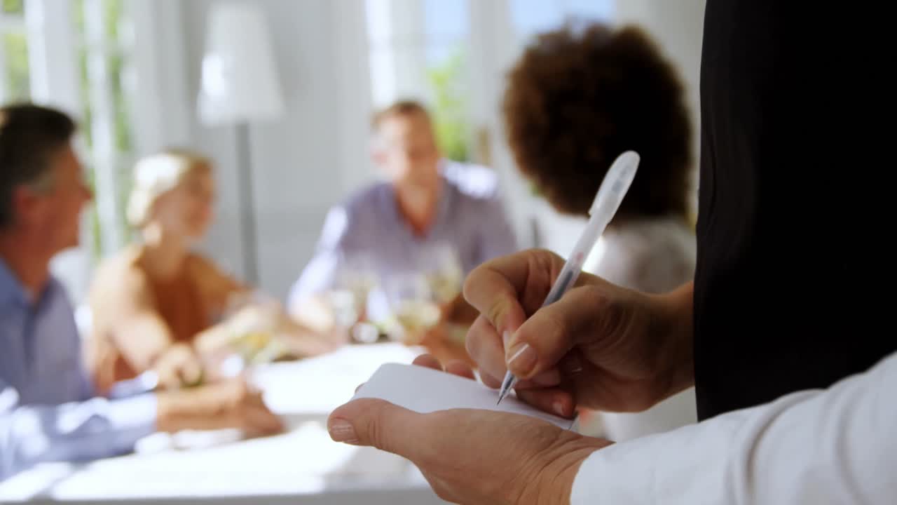 Waitress writing order in notepad