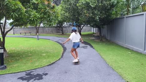 woman skateboarding in park