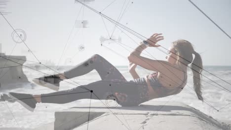 network of connections against caucasian woman performing abs exercise at the beach