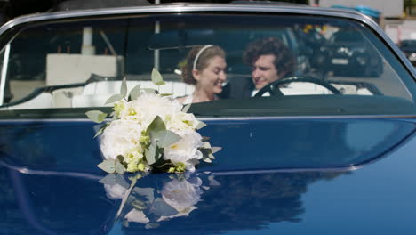 just married couple on a blue car