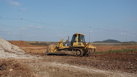 yellow bulldozer working on a construction site