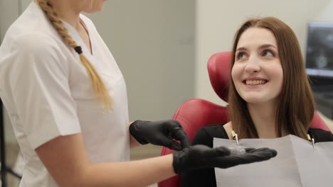 dentist showing dental model to patient