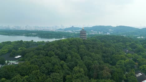 Aerial-closing-to-the-Leifeng-Pagoda,-situated-on-the-southern-shores-of-West-Lake-in-Hangzhou,-China,-captivating-testament-to-both-ancient-Chinese-architecture-and-rich-cultural-history