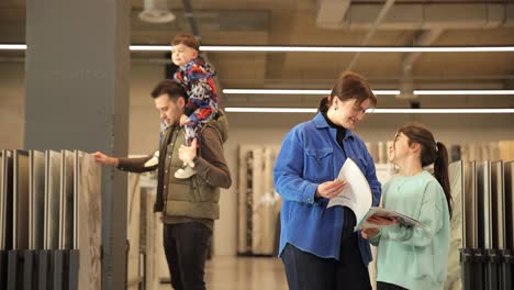 A Friendly European Family in a Ceramic Tile Salon. A friendly European family in a ceramic tile salon. Selection of building materials for home renovation
