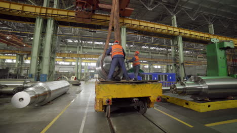 heavy metal components being moved in a factory