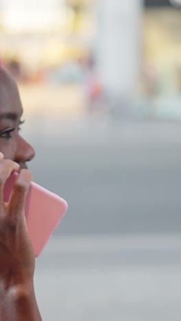 a person with pink hair using a pink smartphone