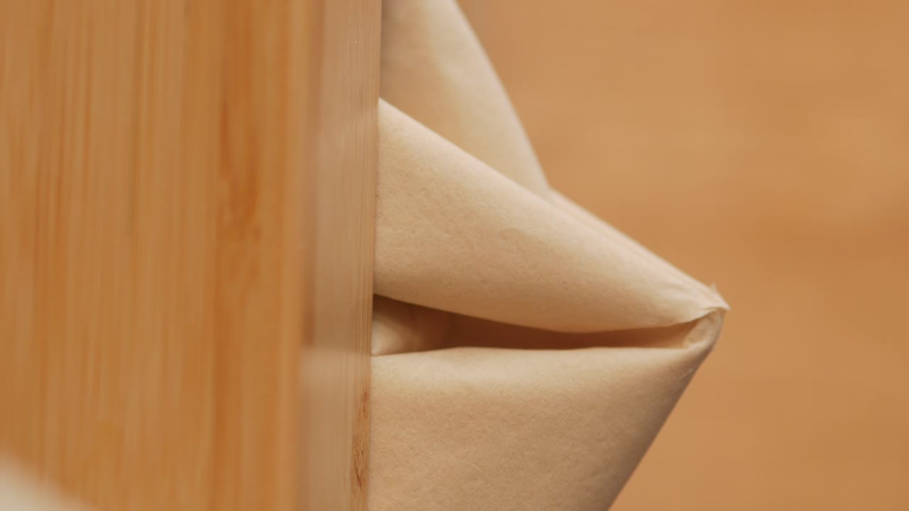 Beige fabric draped over wooden table corner