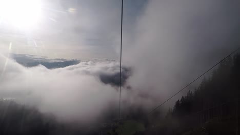 with a cable car up through the clouds where the sun shines