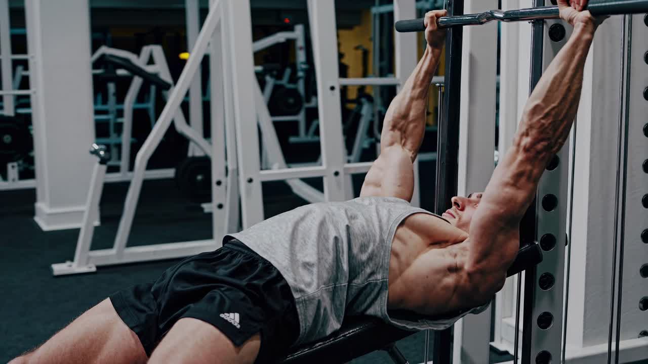 Man performing barbell workout in a gym