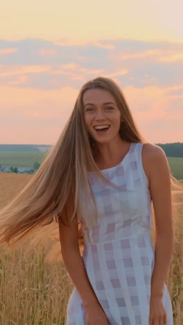 young woman with long hair enjoying a sunny day in a golden field with vibrant sunset colors
