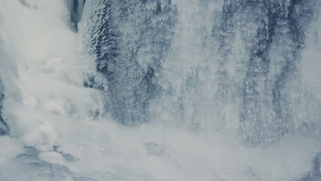 winter background. water flowing under transparent ice. ice surface