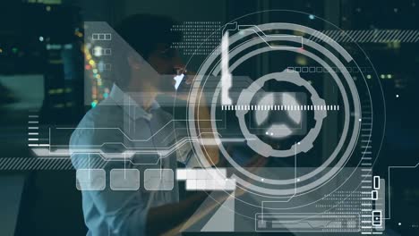 animation of interface with data processing over biracial man talking on smartphone at office