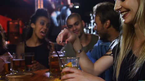 woman having fun while drinking cocktail