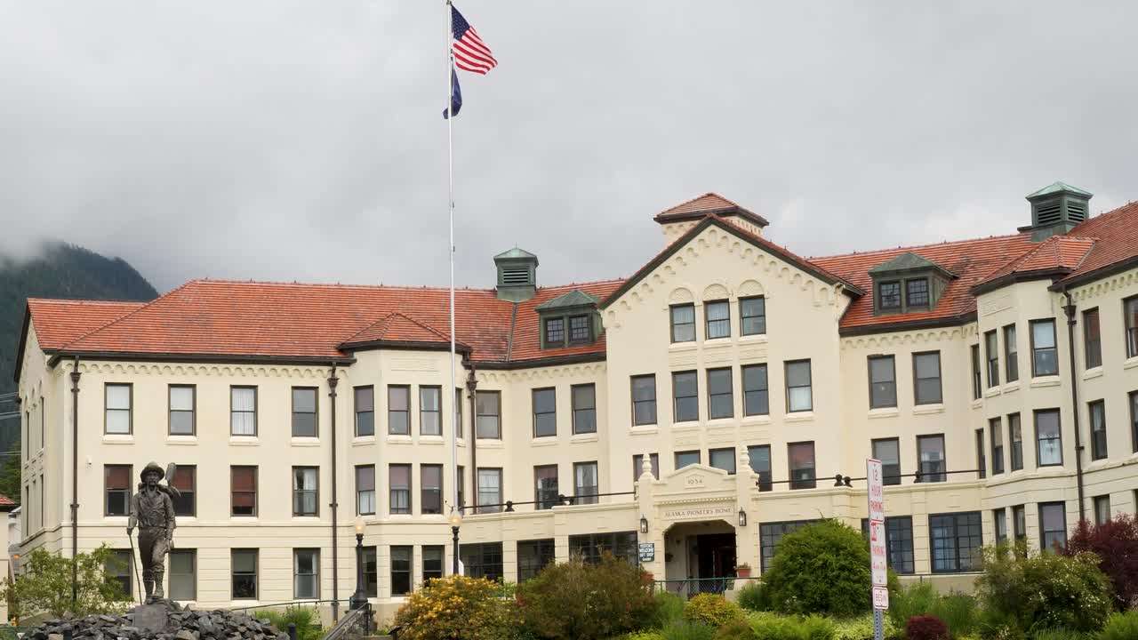 Emblematic building of the Sitka Pioneer Home and "The Prospector" statue in front of the building, Sitka, Alaska.