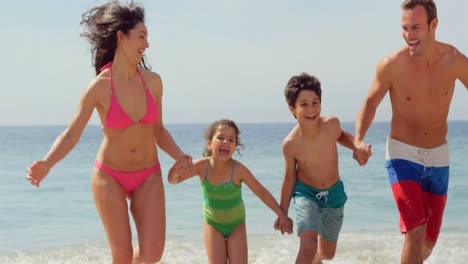 Familia-Feliz-Corriendo-En-El-Agua