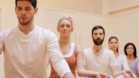 group of people doing meditation