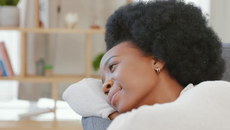 black woman day dreaming and relaxing on sofa