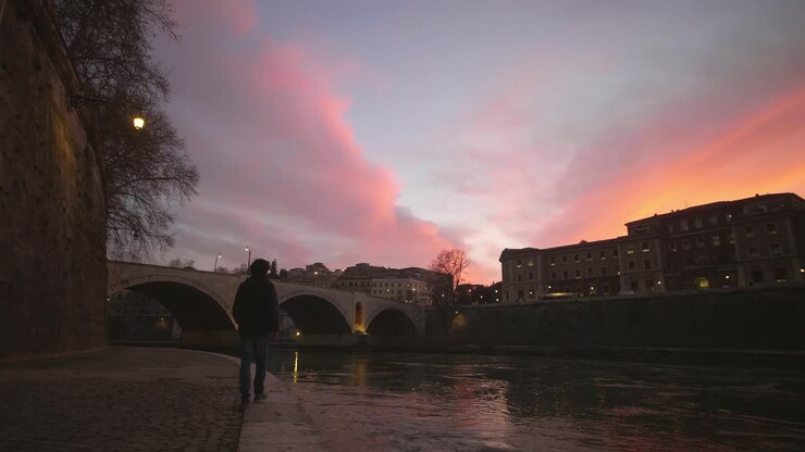 Walking Along River At Sunset