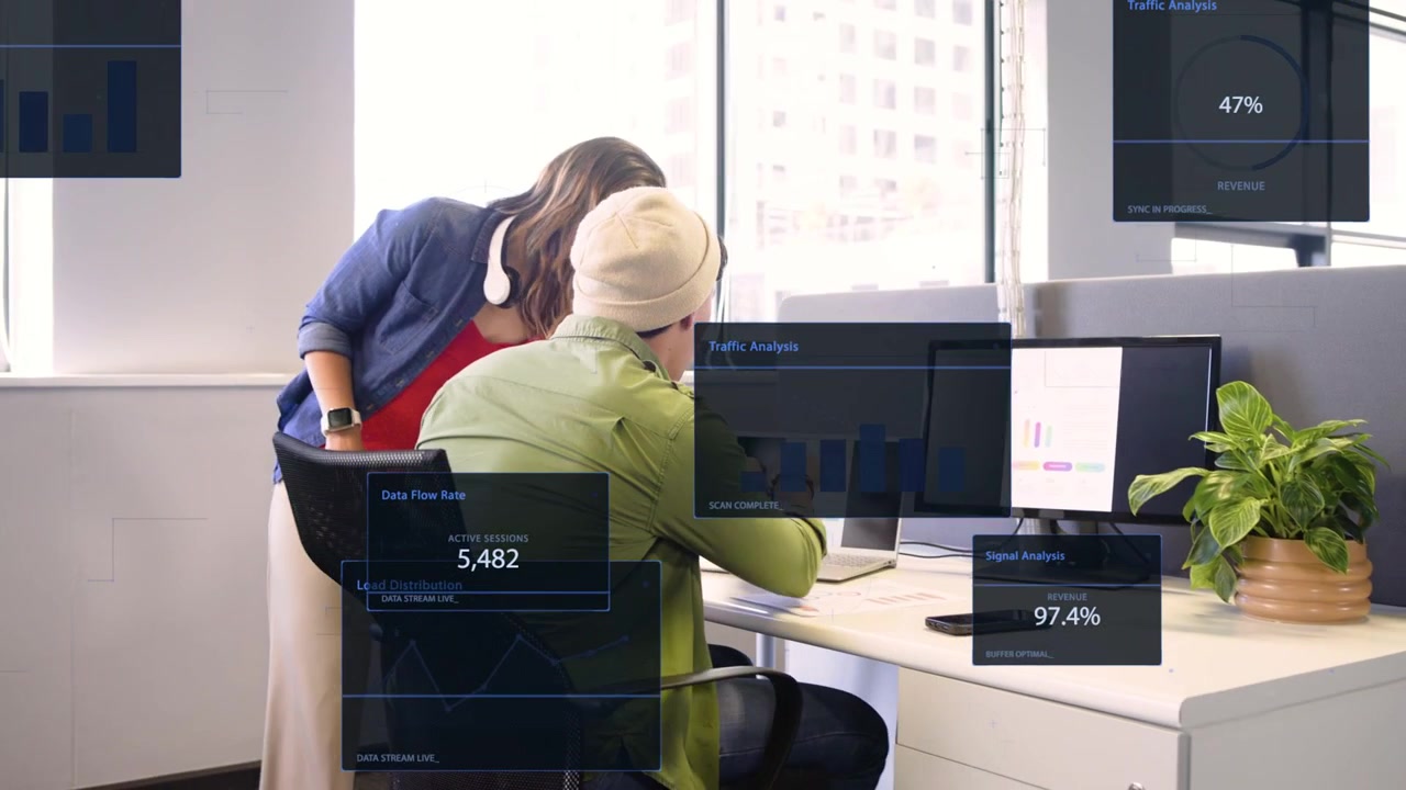 Noticing analytics, woman in blue rising, leaning, pointing as animated charts guiding colleague