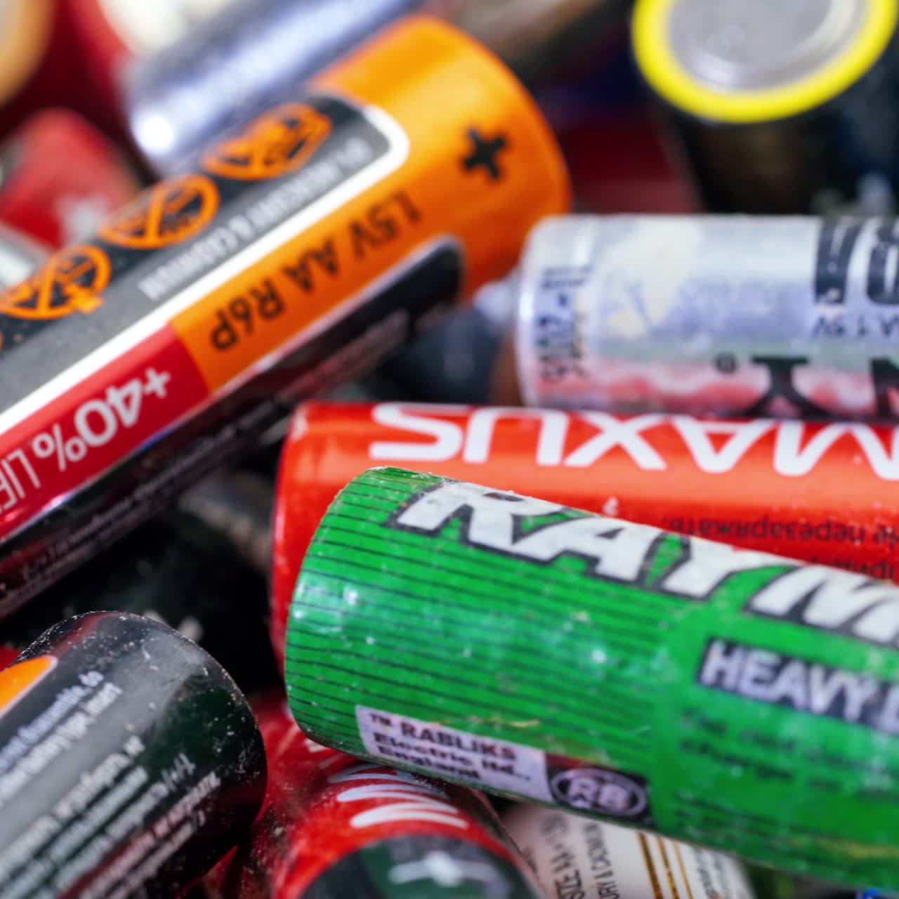 Used batteries from different manufacturers, waste, collection and recycling, high danger for the environment. Batteries background